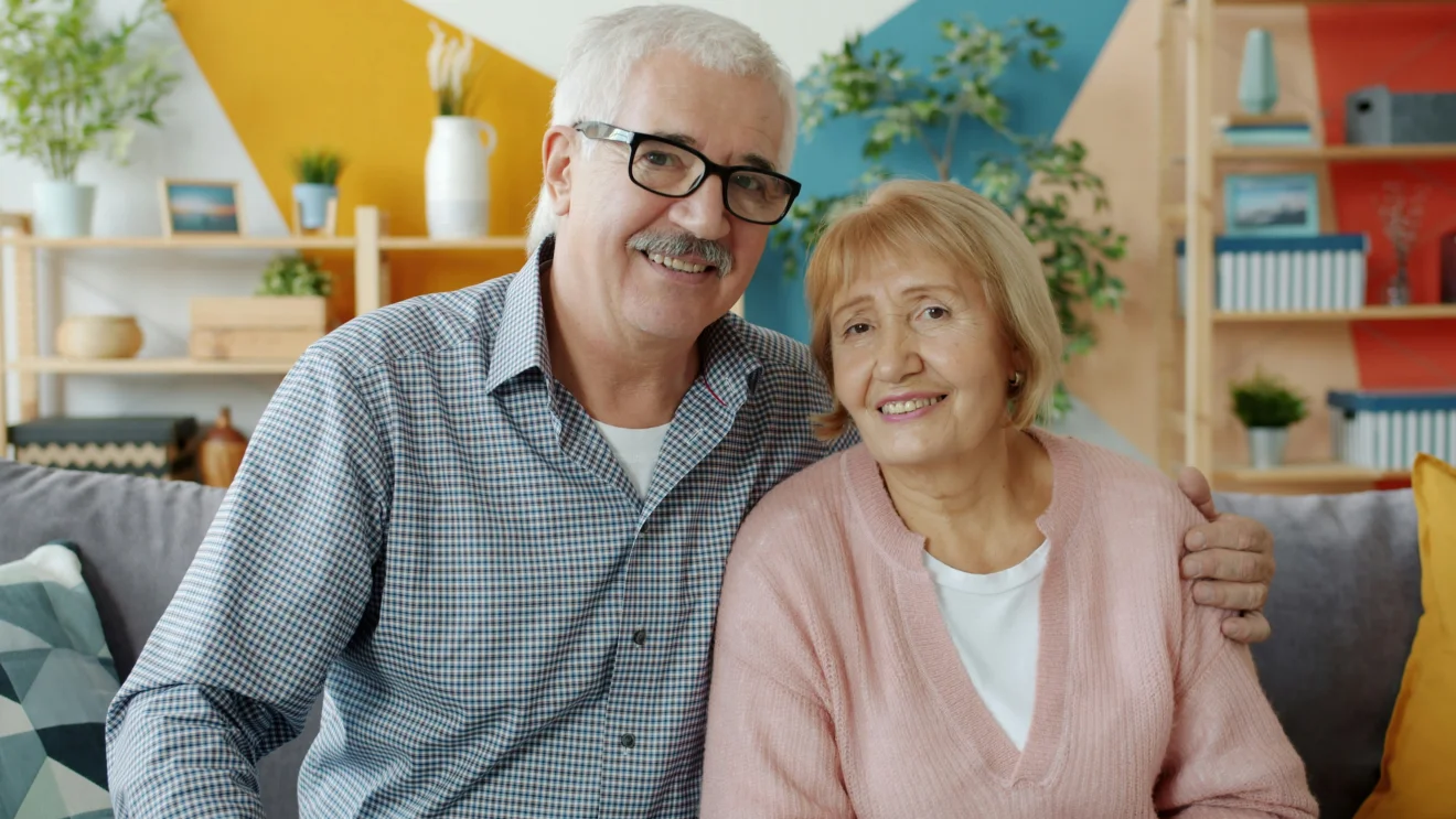 An older couple smiling together.