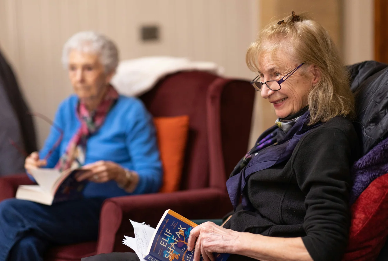 Two older women sitting together.